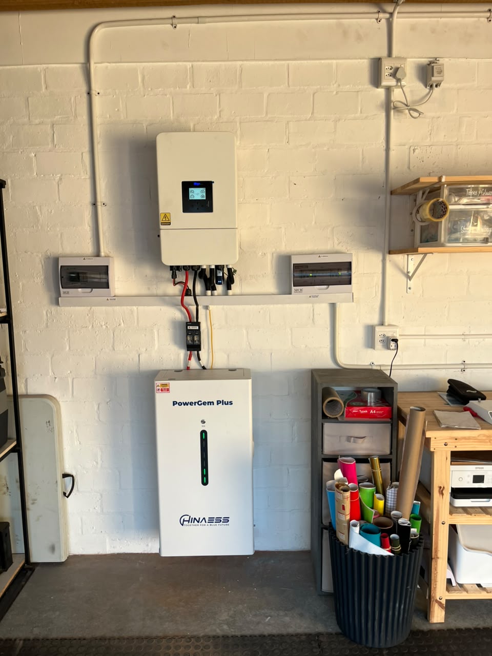 A Sun Savings hybrid inverter and battery installed on a wall