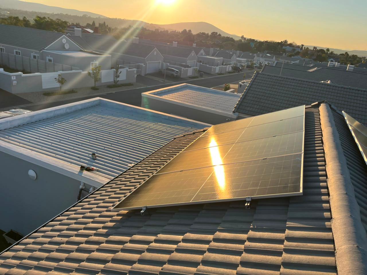 Late afternoon sun across a Sun Savings rooftop array